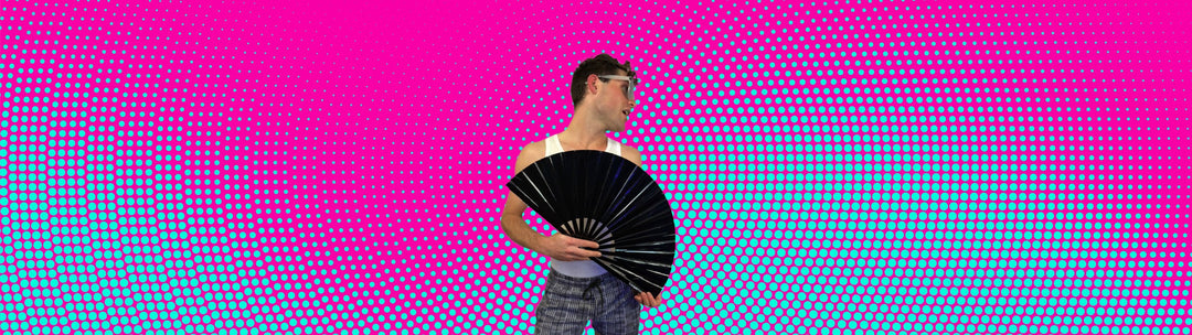 Man holding a silver metallic clack fan at a circuit party