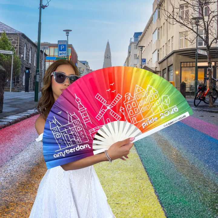 Woman holding a rainbow-colored fan with &