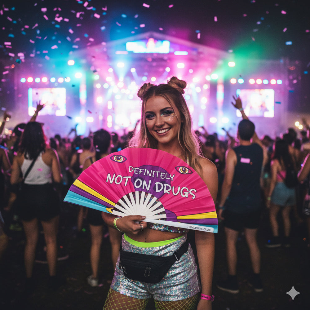 Person holding the "Definitely Not On Drugs" Fan at a rave or festival