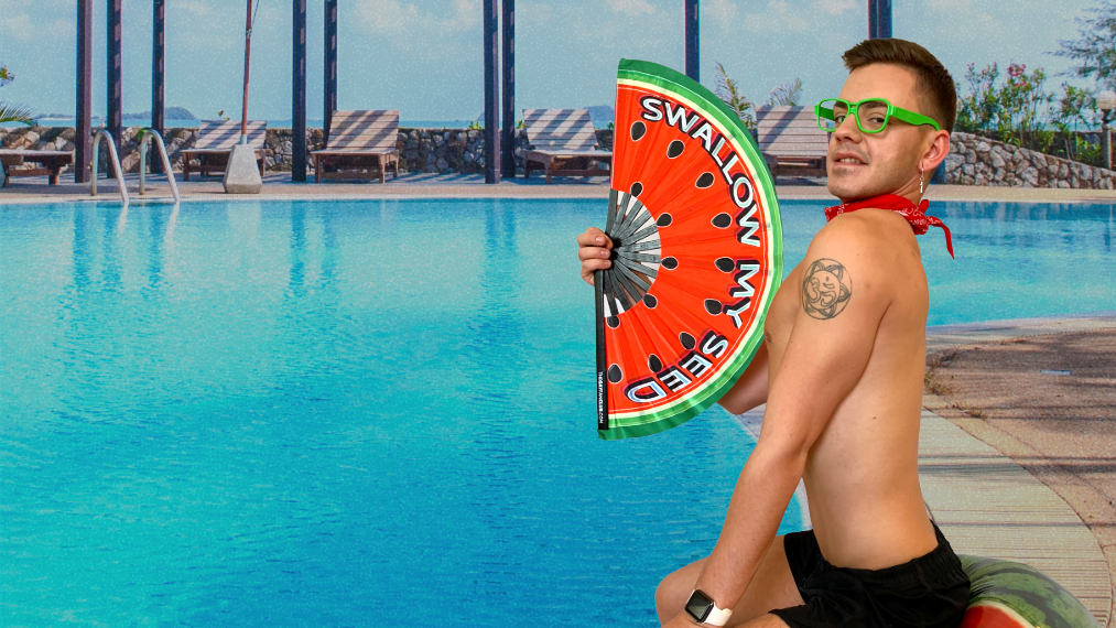 Man sitting by a pool holding a watermelon-themed inflatable pool float.