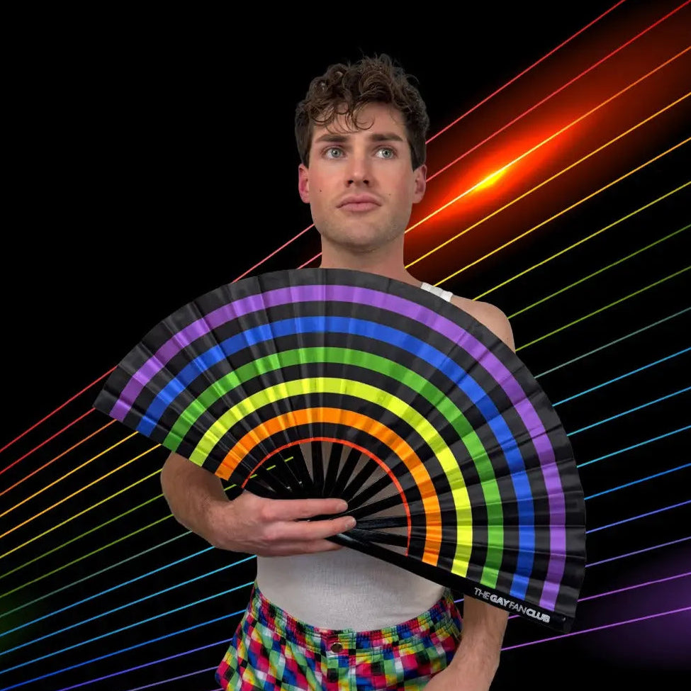 Person holding a rainbow-colored fan with a colorful background