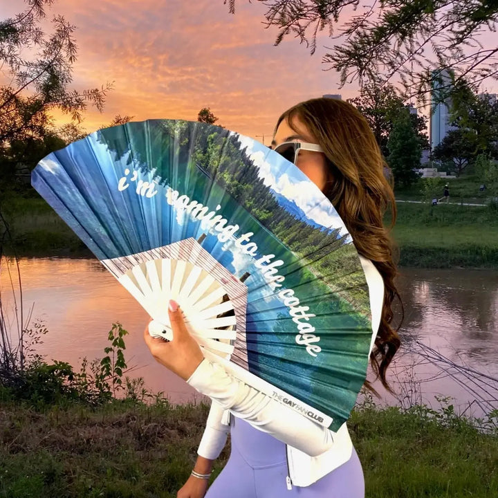 Person holding a fan with the text 
i&