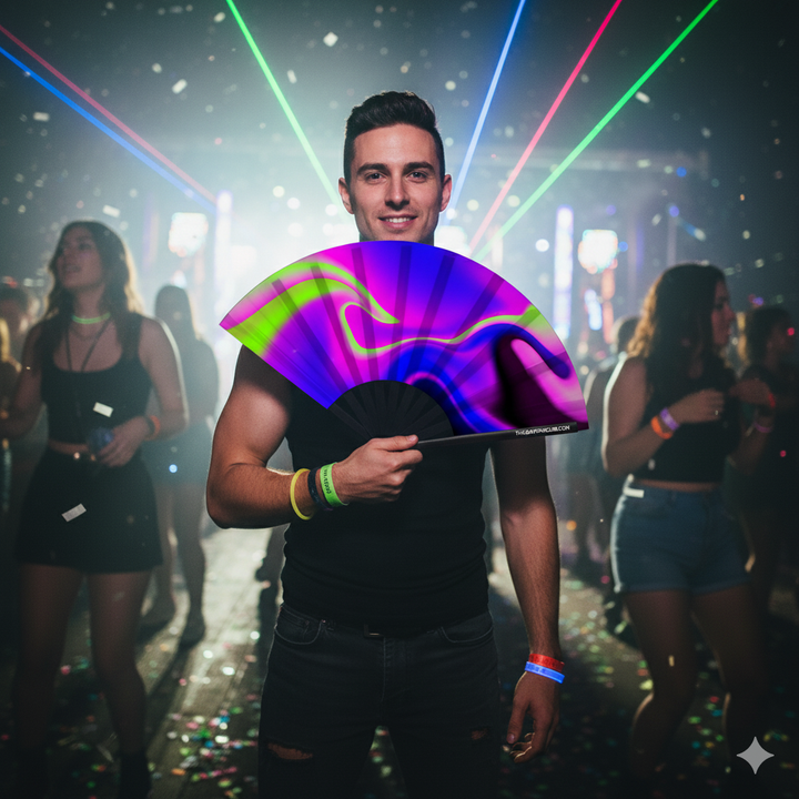 attractive man at rave holding a UV-reactive hand fan from The Gay Fan Club