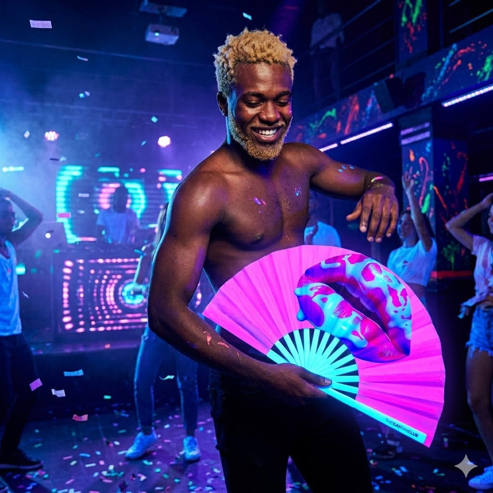 Person holding The Taste The Rainbow UV Fan glowing bright neon pink under blacklight, highlighting the frosted red lip design.